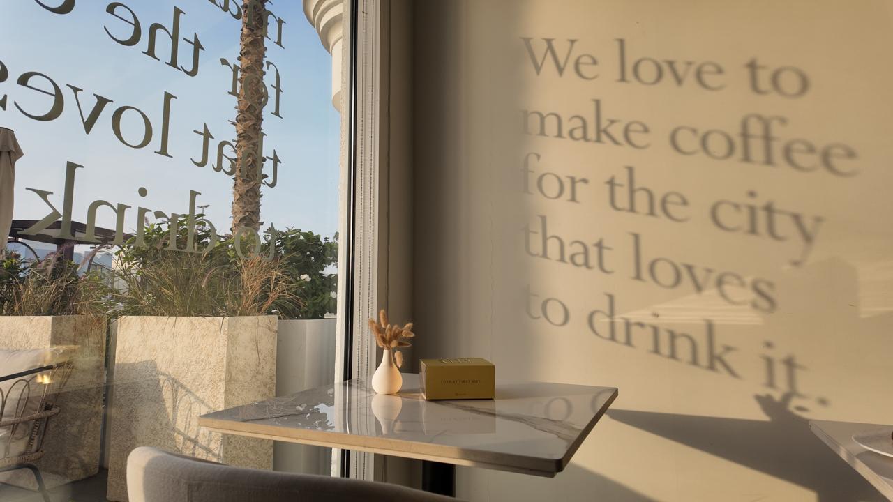 Sunlit Stay window with tagline etched on the glass